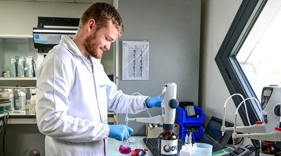 Un technicien d'Odyssée Environnement analyse un échantillon d'eau au laboratoire